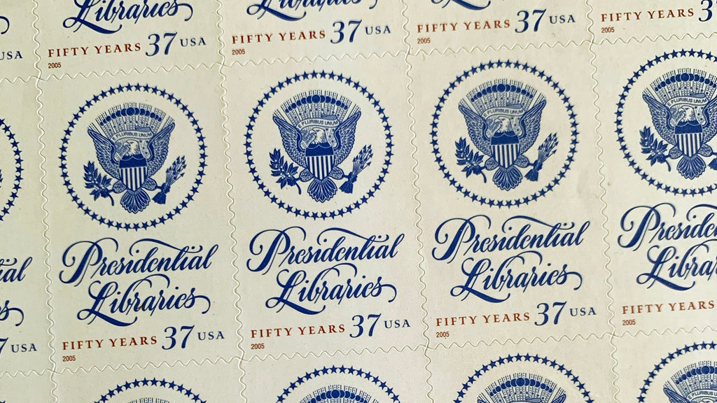 Close-up of the 2005 Presidential Libraries U.S. postage stamp (Scott 3930), 37 cents, featuring the Great Seal of the United States and elegant script celebrating 50 years of the Presidential Libraries Act.
