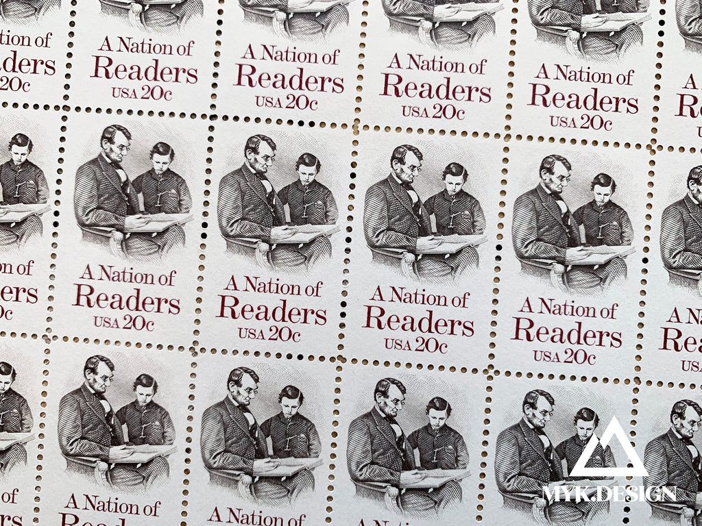 Close-up of the 1984 “A Nation of Readers” U.S. postage stamp (Scott 2106), 20 cents, featuring Abraham Lincoln reading with his son Tad.